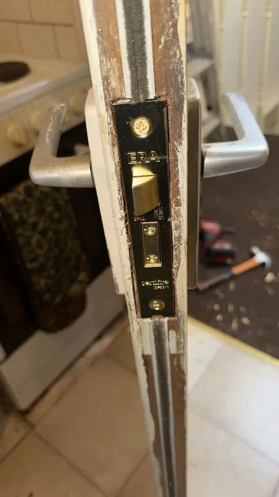 A brass sash lock fitted in the edge of a timber door