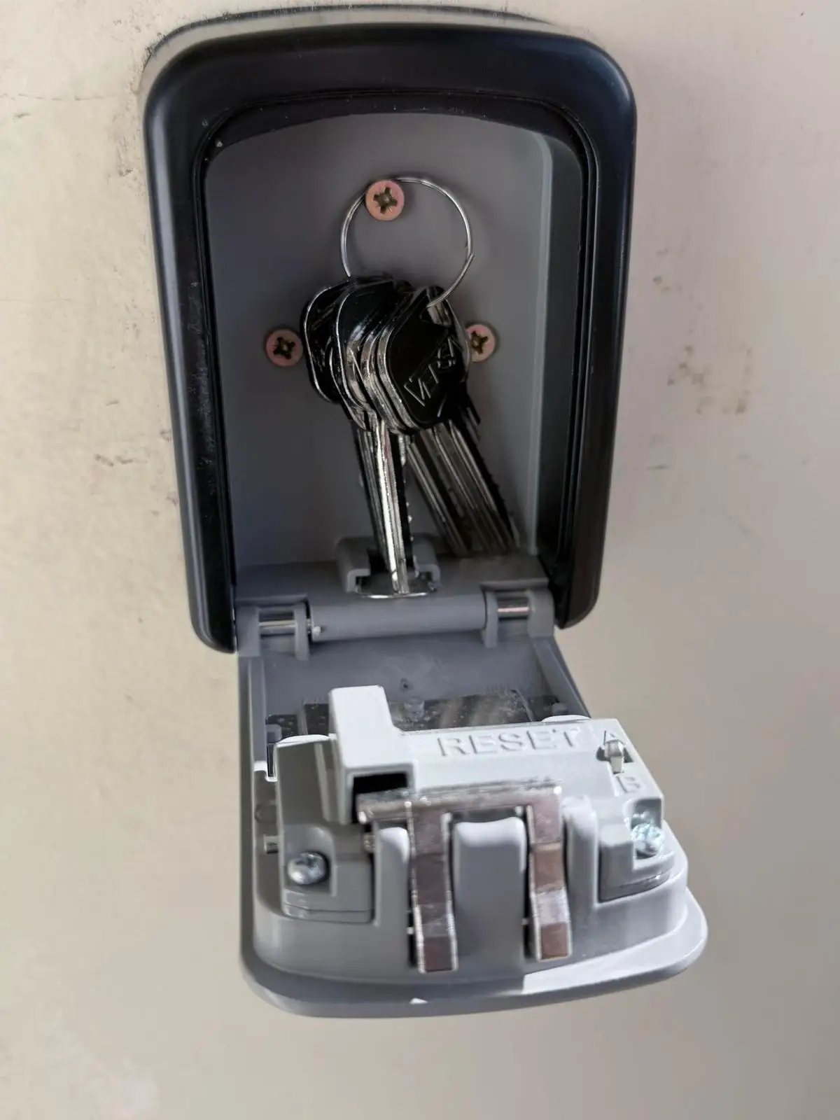 An open key safe with a set of keys hanging inside
